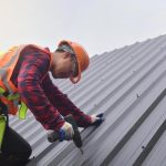 roofer-worker-in-protective-uniform-wear-and-gloves-roofing-tools-installing-new-roofs-under-construction-electric-drill-used-on-new-roofs-with-metal-sheet-free-photo.jpg