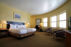Crockett Hotel guest room with king bed and seating area in downtown San Antonio.